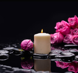 Still life with lying down rose with candle and therapy stones 