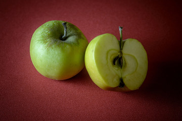 Healthy green apples on red cloth
