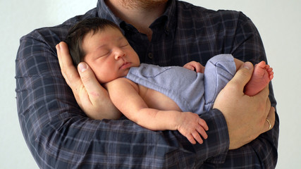 Father holds newborn daughter