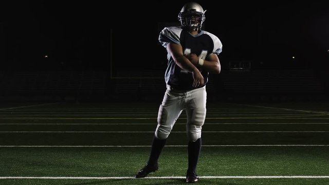 Isolated quarterback throws the ball down the field in front of the camera