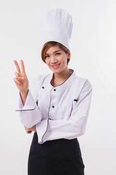 female asian chef pointing up two fingers victory gesture
