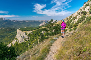 Fototapeta premium Girl tourist standing on mountainside of Demerdzhi