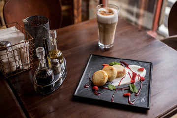 Breakfast from cheesecakes, sour cream and jam