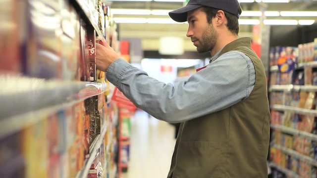 Sales assistant scanning products before putting for sale