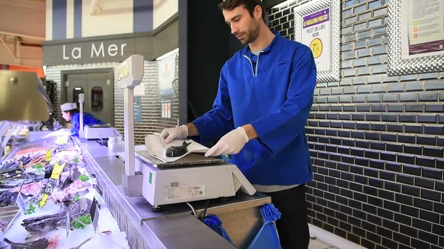 Fishmonger working in supermarket