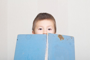 Boy peeping out from book, vintage and old book