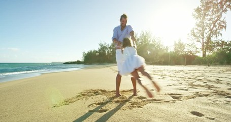 Father and daughter playing on the beach together