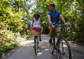 Fototapeta na wymiar Young couple having joyful bike ride in nature