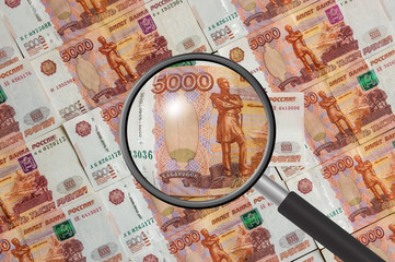 Russian money background with magnifying glass