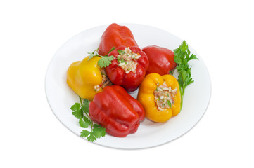 Stuffed bell peppers and twigs of greenery on white dish