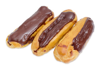 Eclairs with chocolate icing on a light background