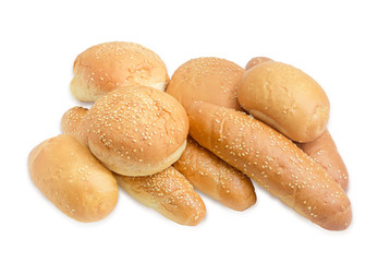 Several different buns, sprinkled with sesame seeds