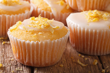 Delicious lemon muffins with icing and zest macro. Horizontal