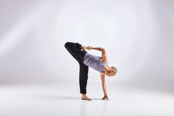 Man doing yoga isolated on white background