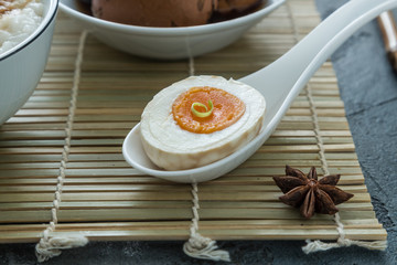 Cutted tea egg with star anise on bamboo mat