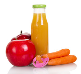 Bottle of juice, apples, carrots and dummy isolated on white.