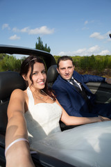 Loving bride and groom on their wedding car