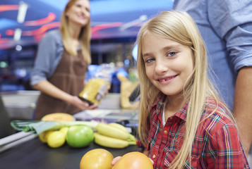 Small girl helping doing the shopping