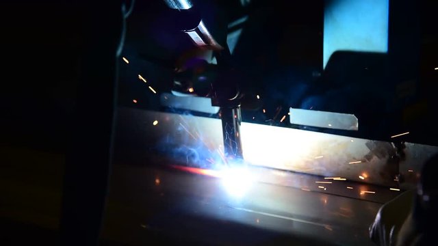Welding robots movement in a car factory  welding splashes brews argon
