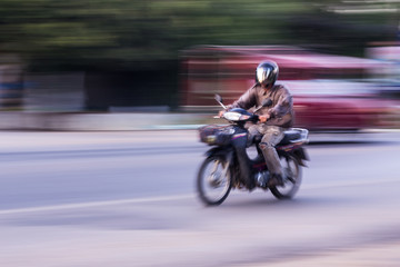 motorcycle panning in road, Asia