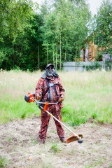 Man mowing grass with a trimmer