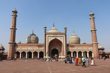 Fototapeta na wymiar Jama Masjid of Delhi, is one of the largest mosques in India. Unidentified people walk in courtyard of Jama Masjid located in Old Delhi, India. 