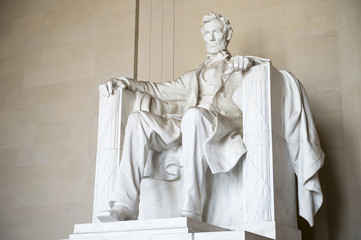 Statue of American president Abraham Lincoln seated in white marble at Lincoln Memorial in...