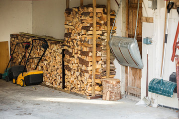 Courtyard village house. European House. The room for the firewood storage. Firewood stacked.