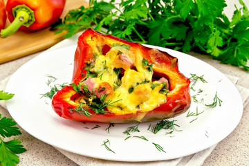 Pepper stuffed with sausage and cheese in plate on stone table