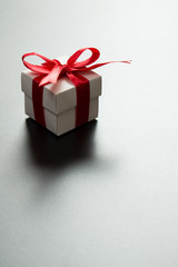 White gift box with red ribbon