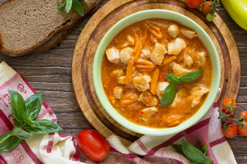 Traditional hot stew with meat on the aged wooden background. He