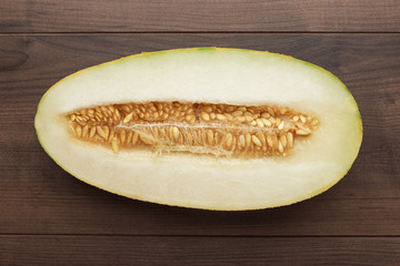 half of sweet melon on the wooden table