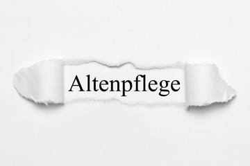 Fototapeta premium Altenpflege auf weißen gerissenen Papier