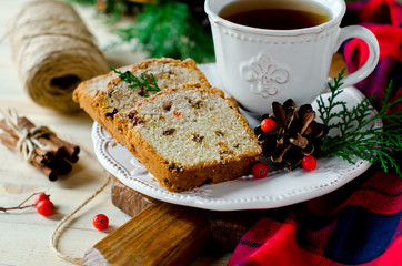 Traditional Christmas cake with dried fruits, raisins and a cup