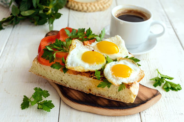 Bruschetta with quail egg, bell pepper, herbs and a cup of coffee. Light breakfast.