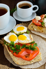 Bruschetta with quail egg, bell pepper and herbs. Light breakfast.