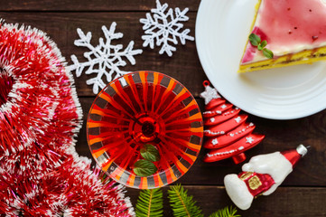 Sponge cake with a layer of banana, milk cream and cranberry syrup. Holiday dessert for Christmas. The top view