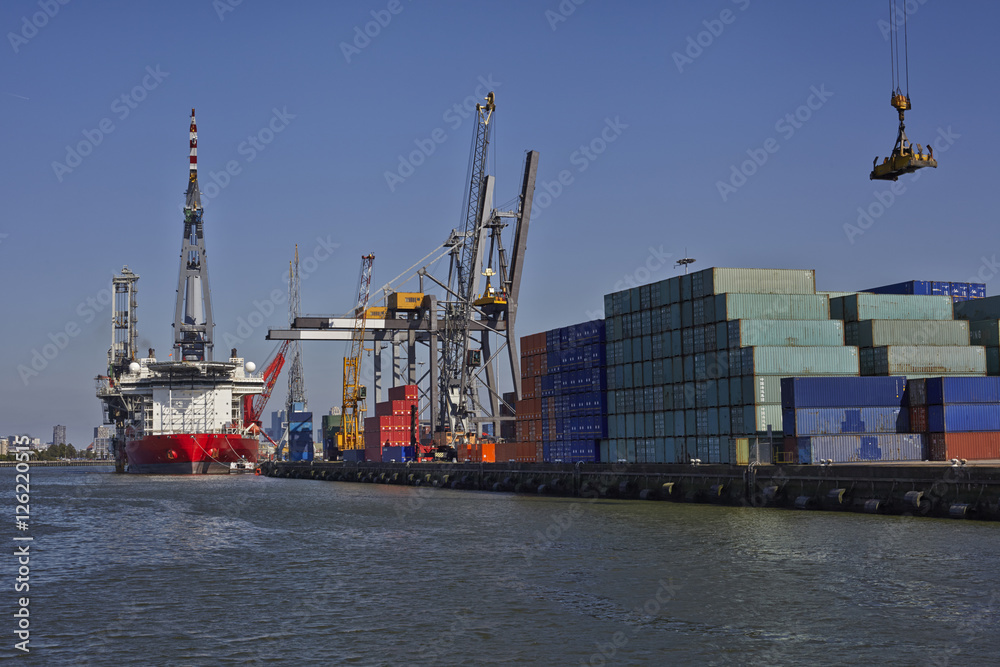 Wall mural large harbor cranes loading a large container ship