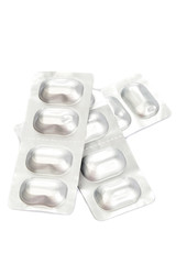 Pills in blister packs on white background.