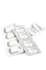 Pills in blister packs on white background.