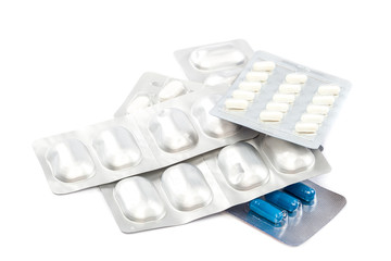 Pills in blister packs on white background.
