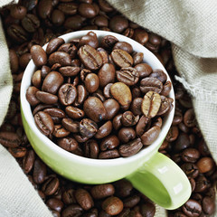Green cup in coffee bag