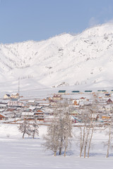 Winter rural landscape in Siberia. The village in the Altai moun