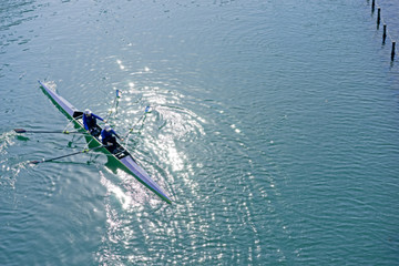 Water sports image, people rowing in canoe on river