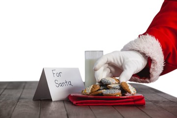 Close-up of santa claus taking cookies