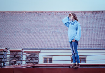 Young woman posing on the roof. Lifestyle. Autumn portrait. 