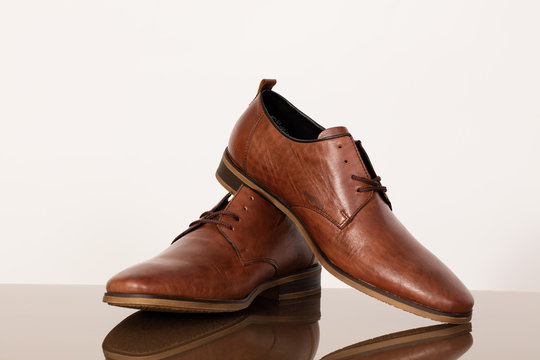 Brown leather shoes for men on a white background