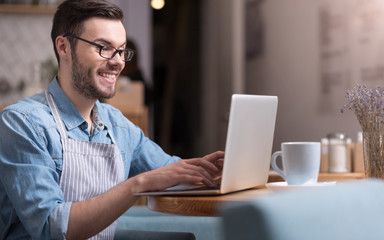 smiling happy man working on laptop.