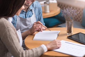 Smiling couple of cafe owners working