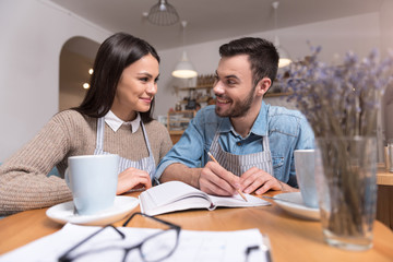 Satisfied young couple making notes